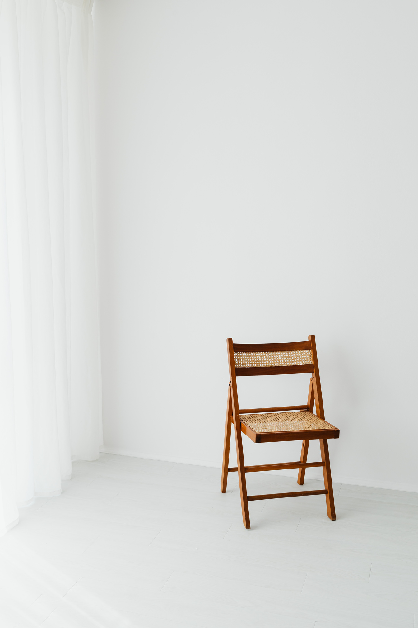 Wooden Chair in a Room with White Walls 